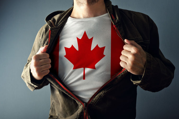 I guy holding his jacket open showing his Canadian flag shirt underneath.